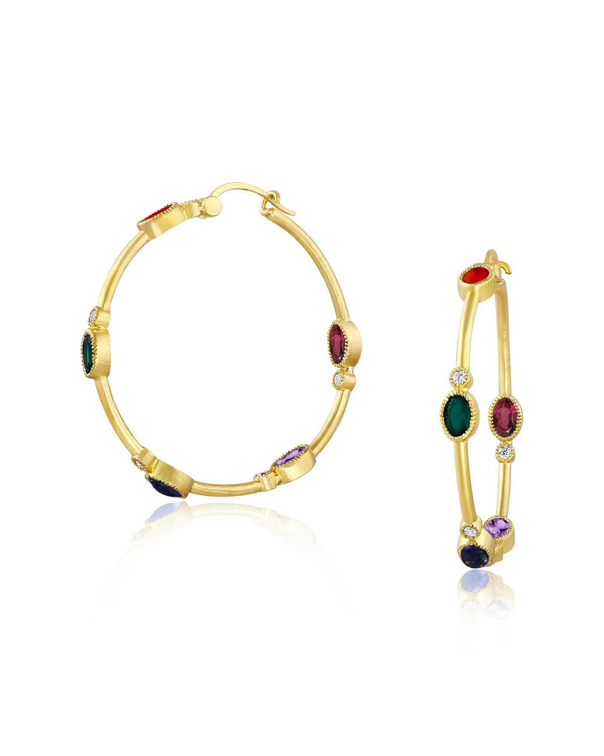 Gold hoop earrings with gemstones on a white background
