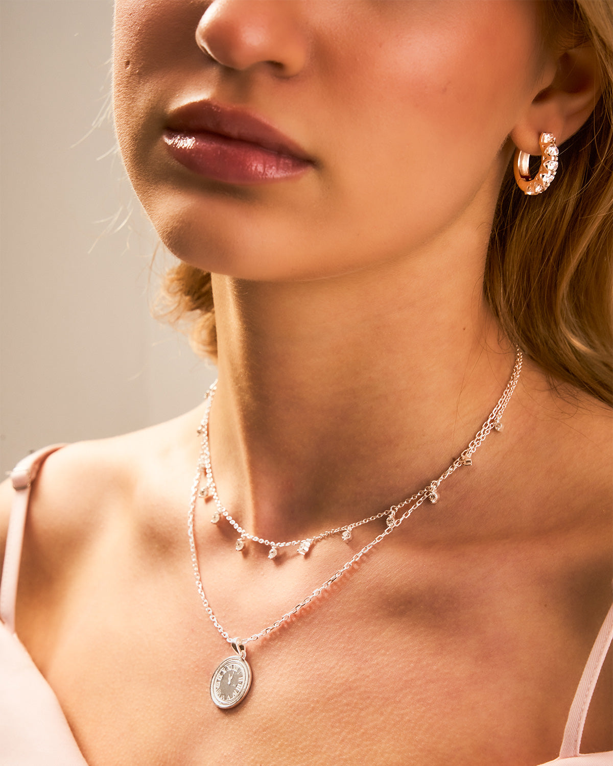 Close-up of a woman wearing a necklace and earrings