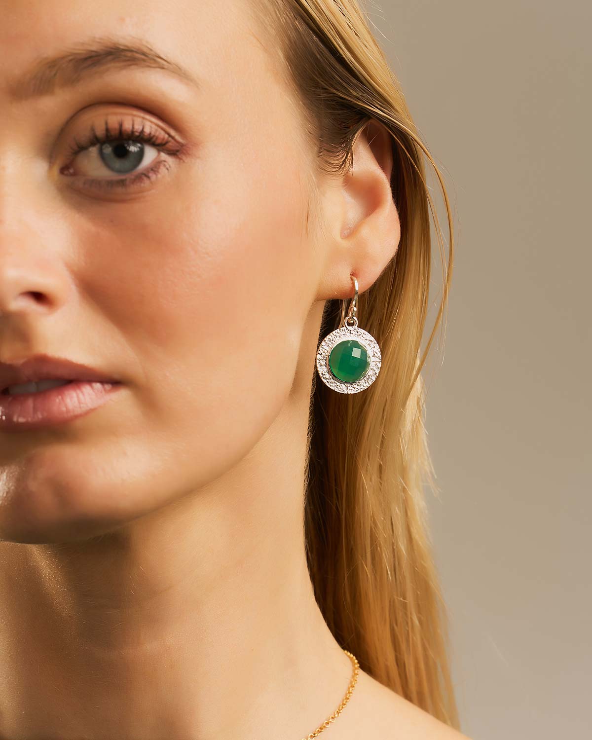 Front view of sterling silver earrings with circular green onyx gemstones