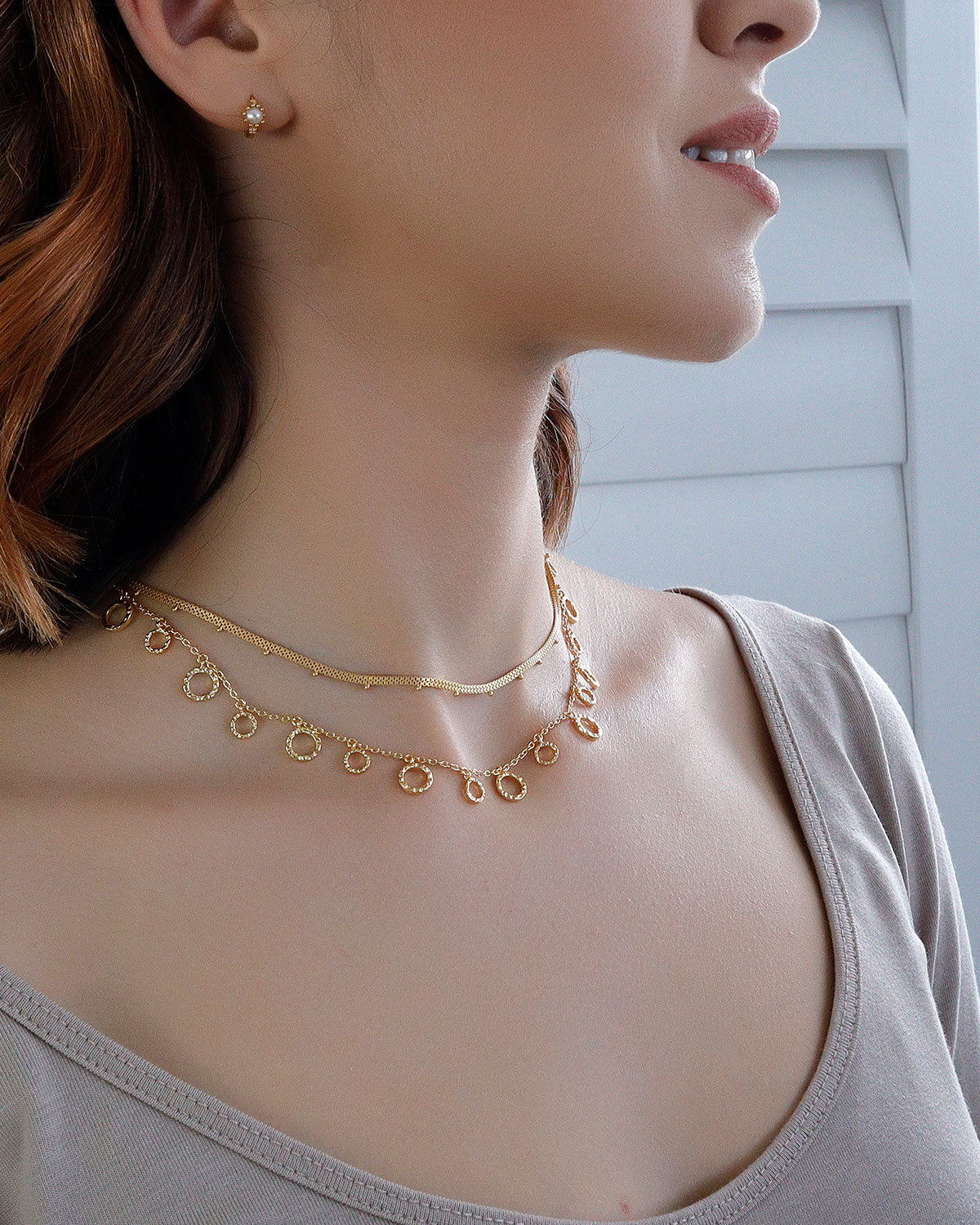 Model wearing gold vermeil necklace with a simple elegant design