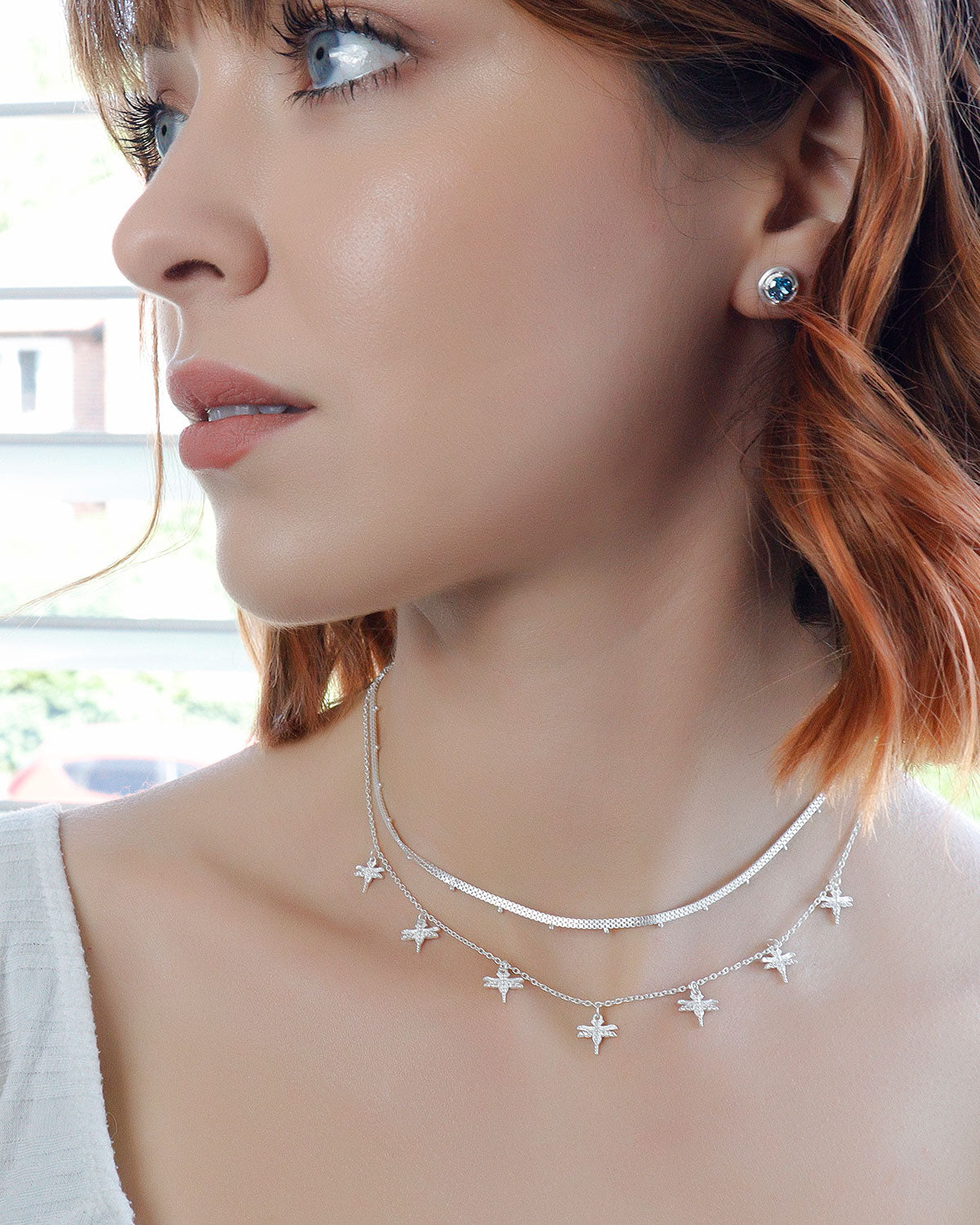 Sterling silver necklace styled in a layered look with other pieces