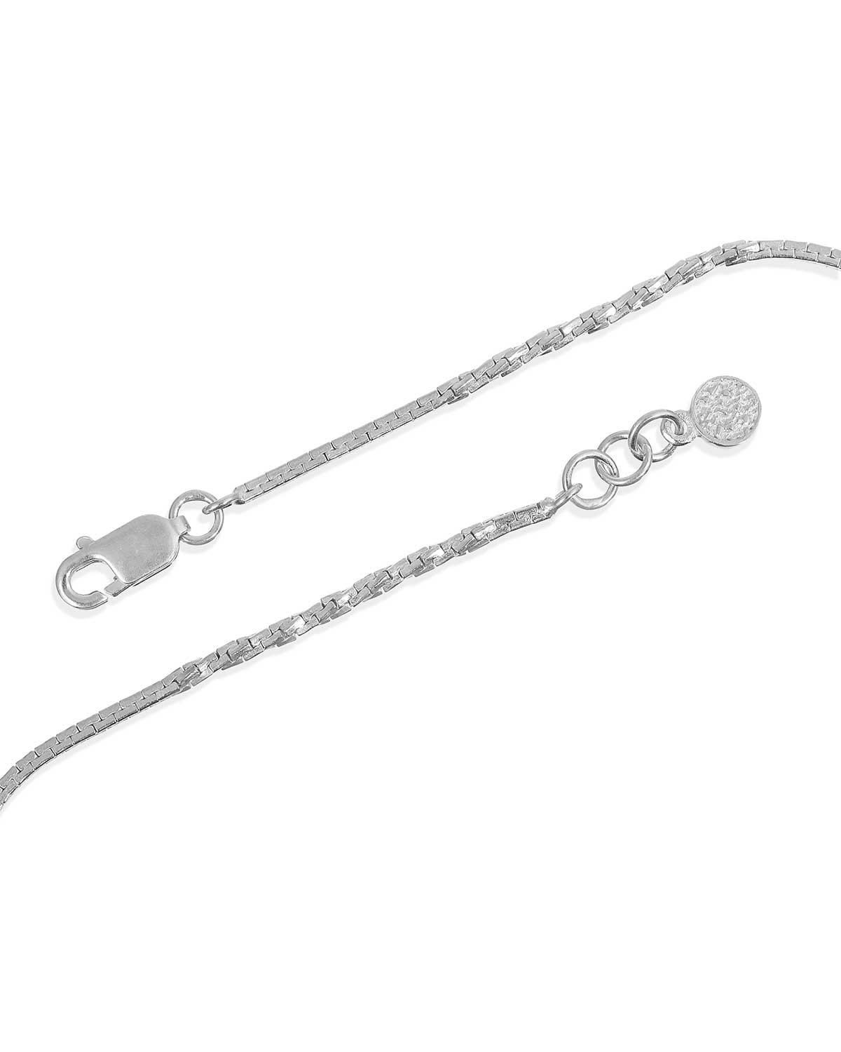 Sterling silver anklet layered with other jewellery pieces for a styled look