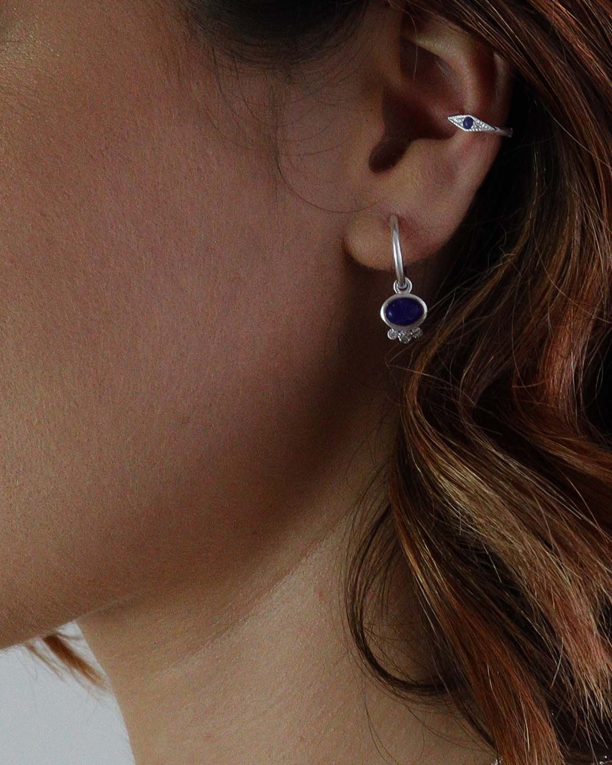 Close-up of mini hoops with lapis lazuli charm and tiny crystal accents