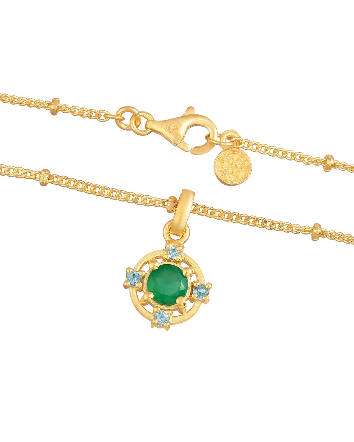Detailed view of green onyx and blue topaz gemstones in gold necklace