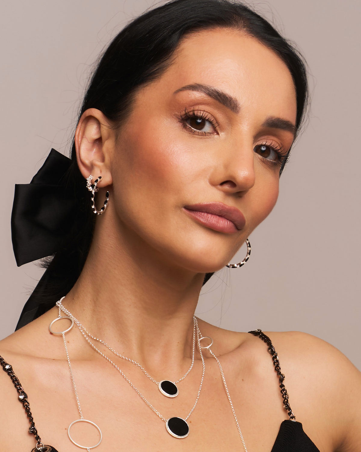Gold vermeil hoop earrings with black spinel gemstones and a polished finish