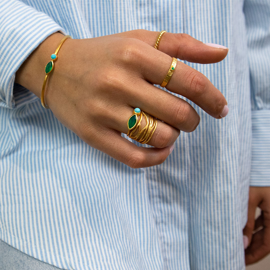 Gold gemstone rings styled together with green onyx and turquoise stones