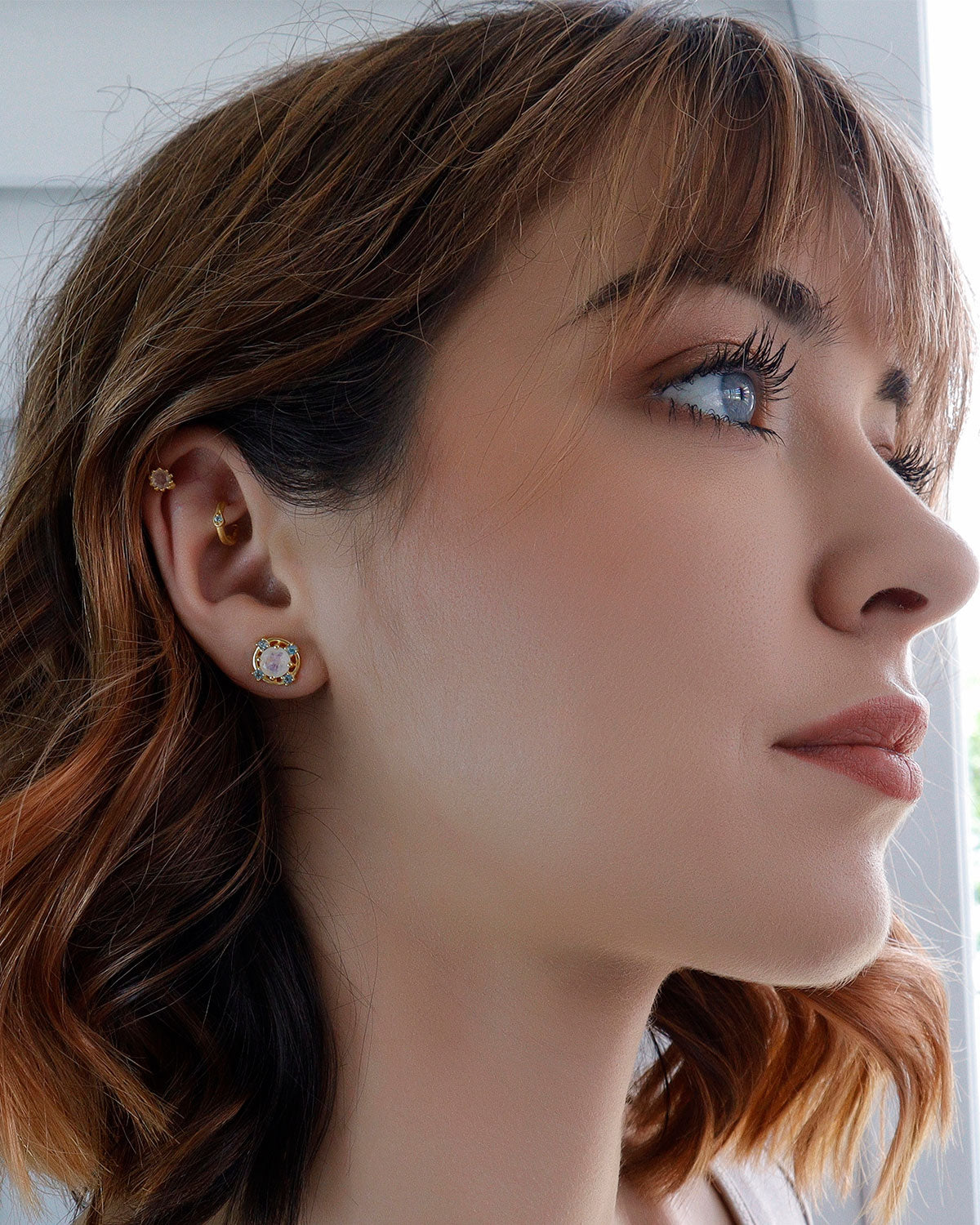 Duo crystal gold stud earrings with moonstone and blue topaz gemstones