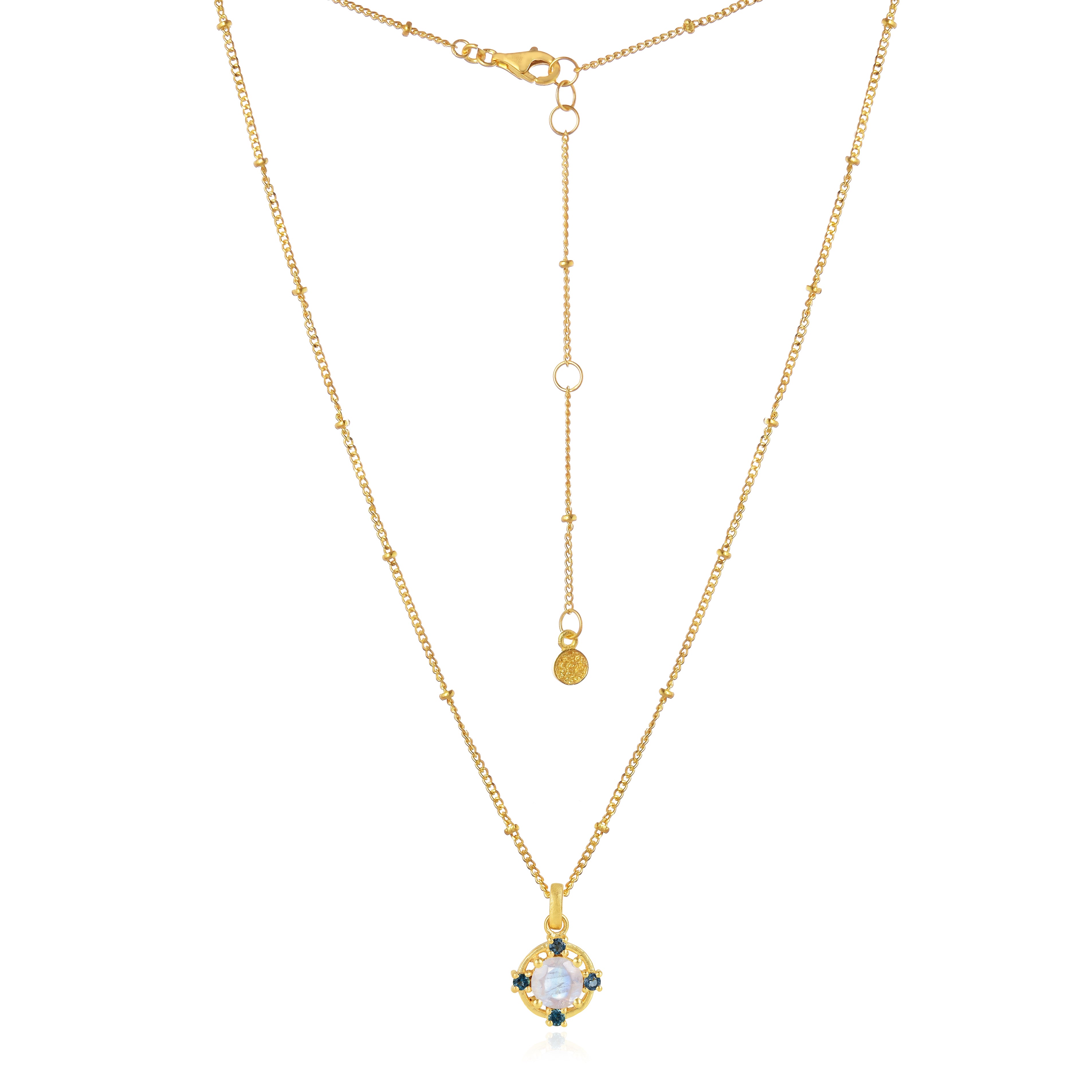 Detailed view of moonstone and blue topaz on gold necklace