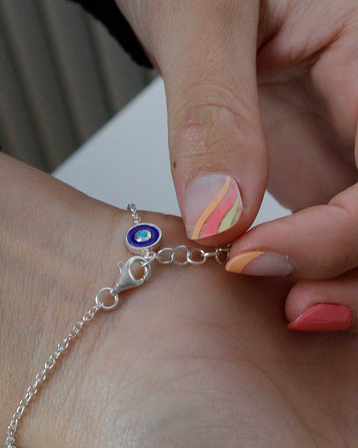 Adjustable silver bracelet with evil eye charm and turquoise gemstone