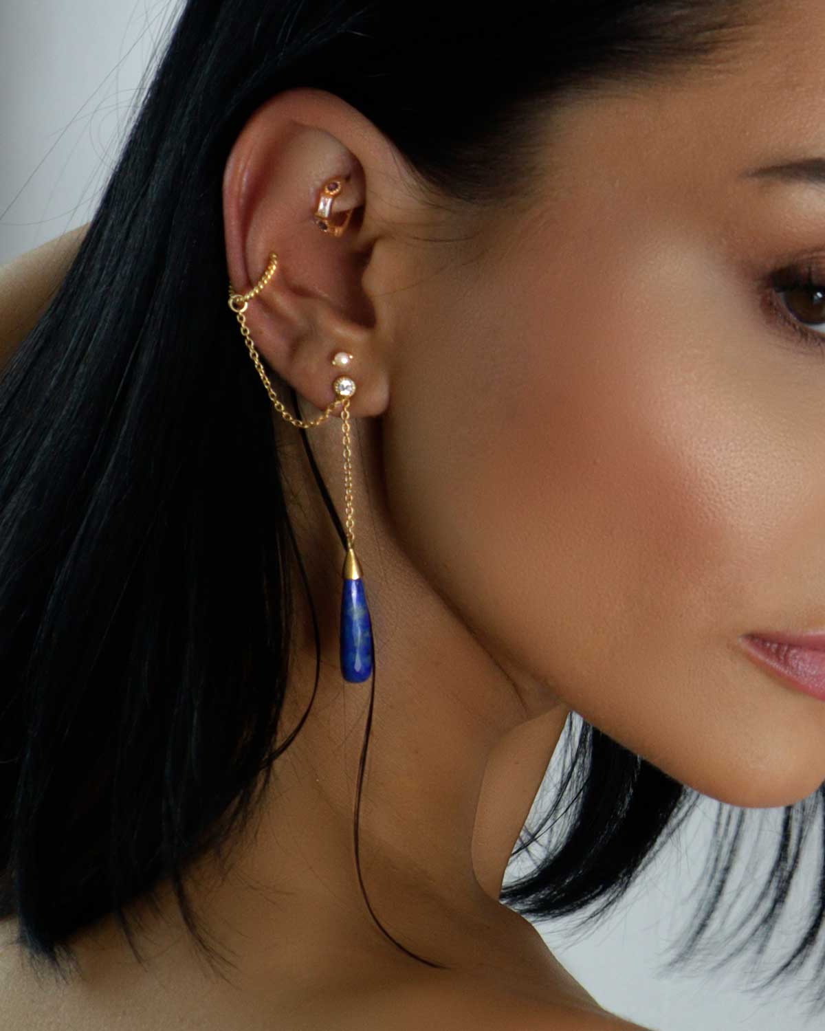 Gold vermeil earrings styled as an ear cuff with lapis lazuli