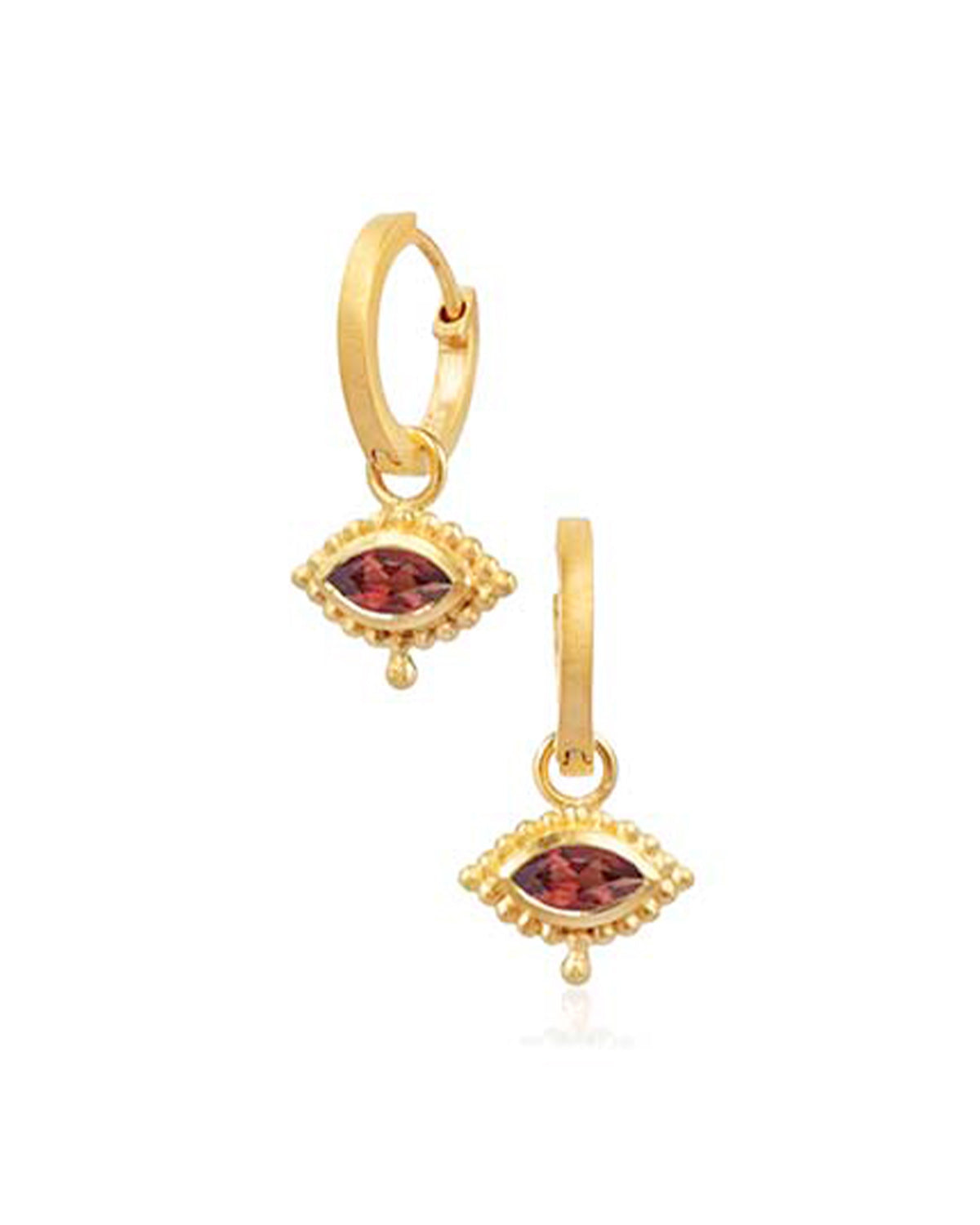 Gold mini hoops styled with other earrings for a layered look