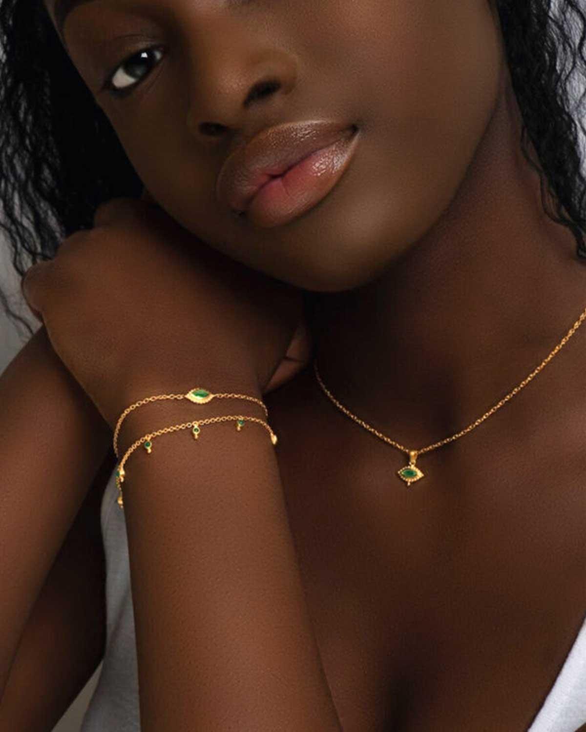 Model wearing silver bracelet with mixed gemstone charms