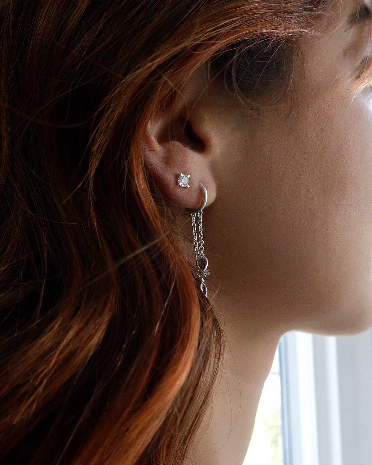 Minimal silver diamond studs with a refined matte finish and modern style