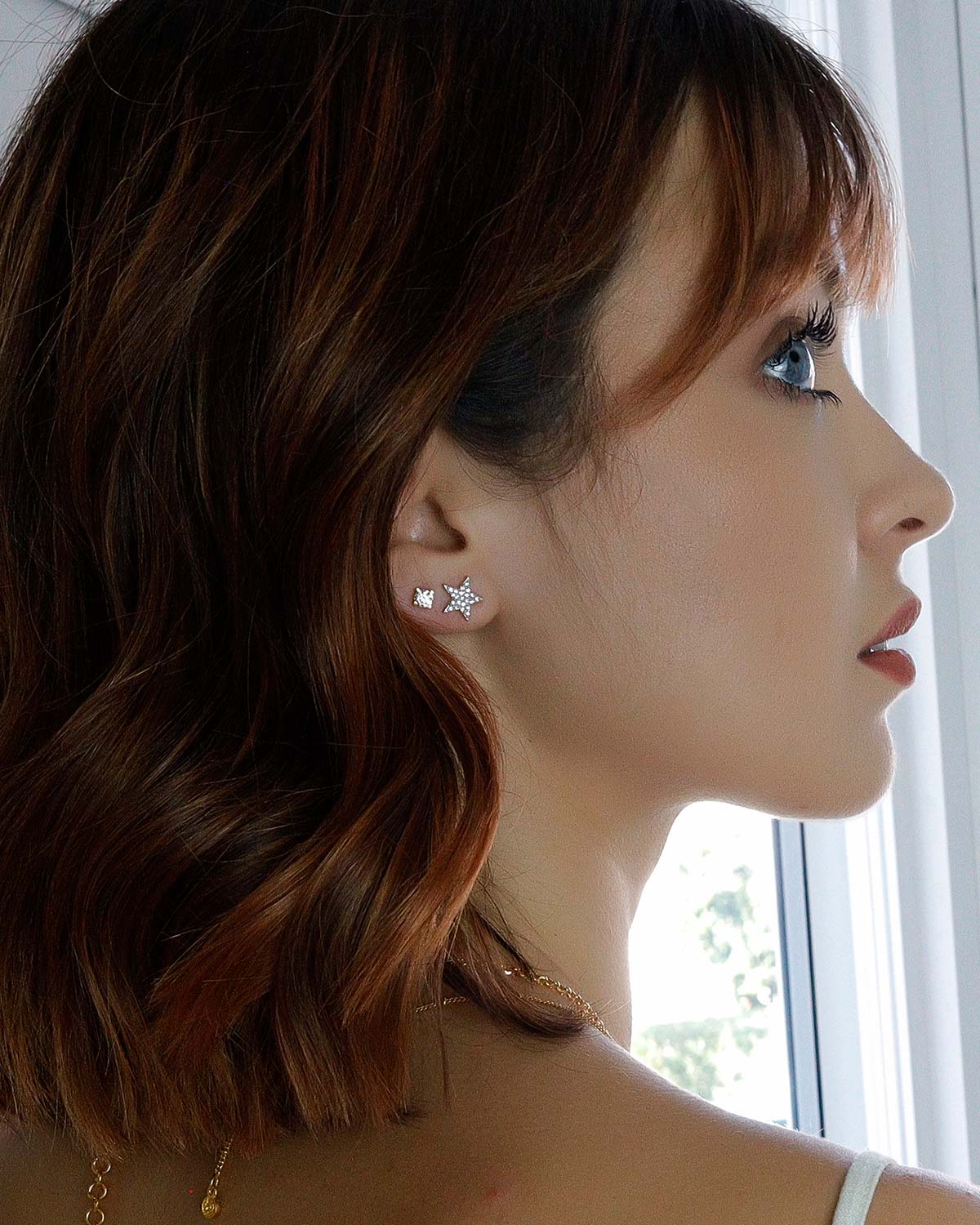 Side view of silver stud earrings with a secure diamond setting