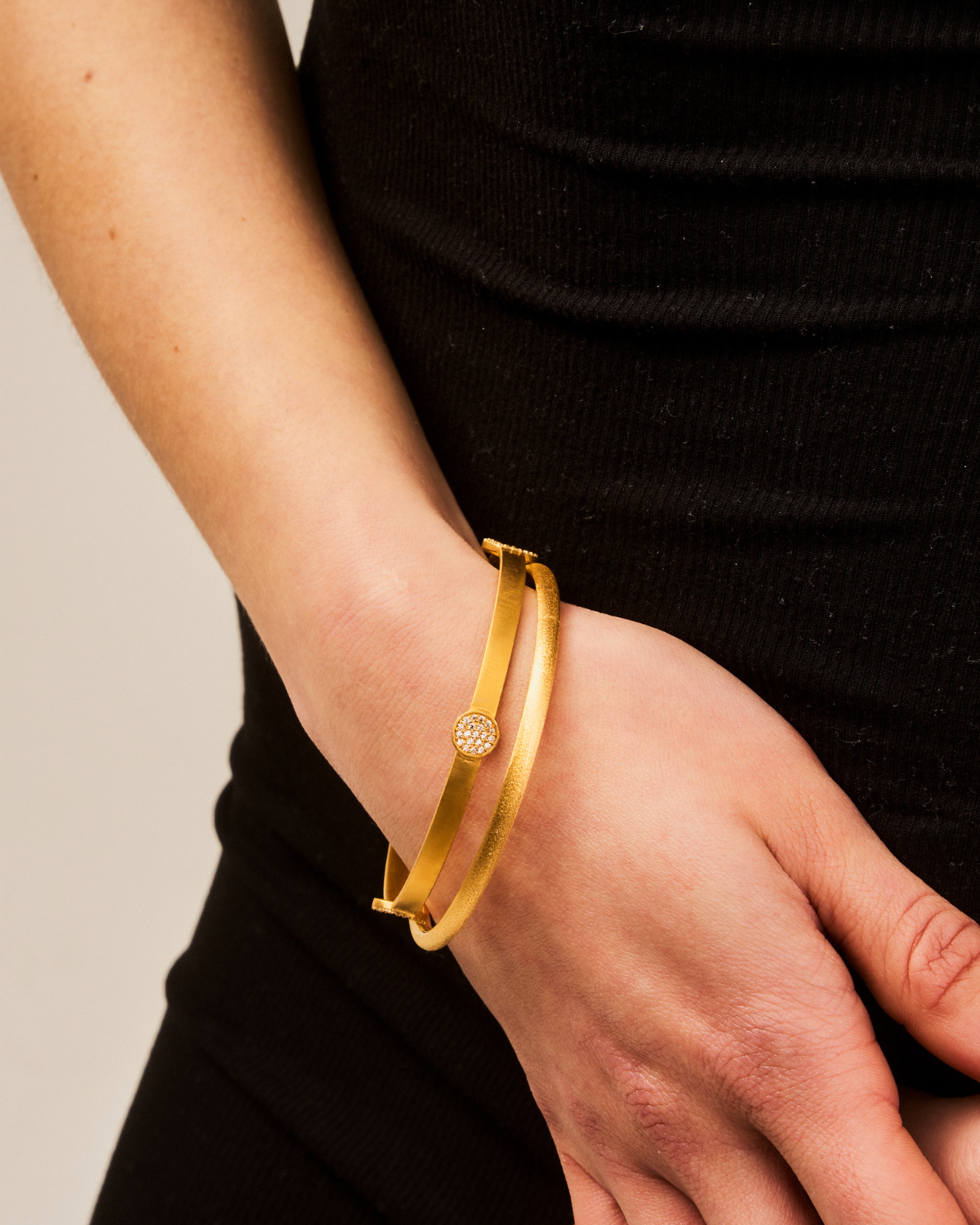 Front view of gold bangle with fine crystal embellishments