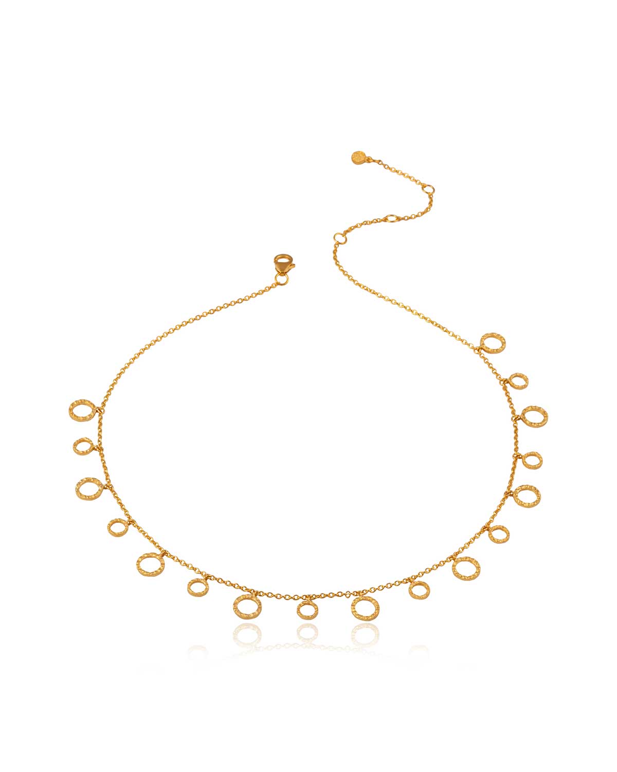 Close-up of gold necklace with a hand hammered disc texture