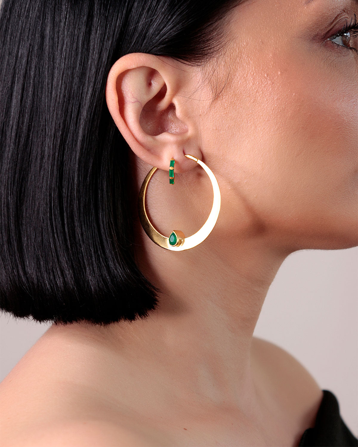 Bold gold hoop earrings with green onyx gemstone details