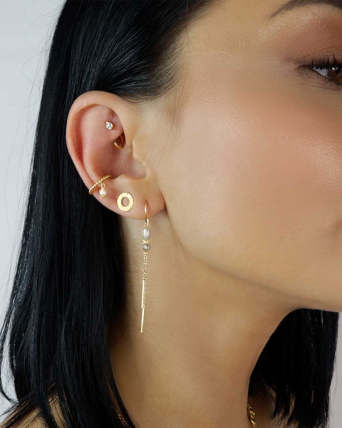 Gold earrings with turquoise gemstones paired with pearls