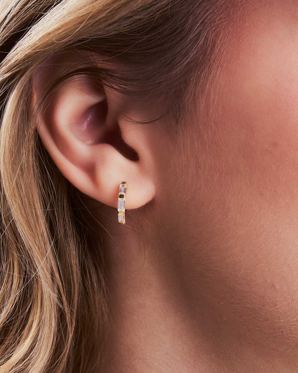 Versatile gold mini hoop earrings with baguette cubic zirconia for everyday wear