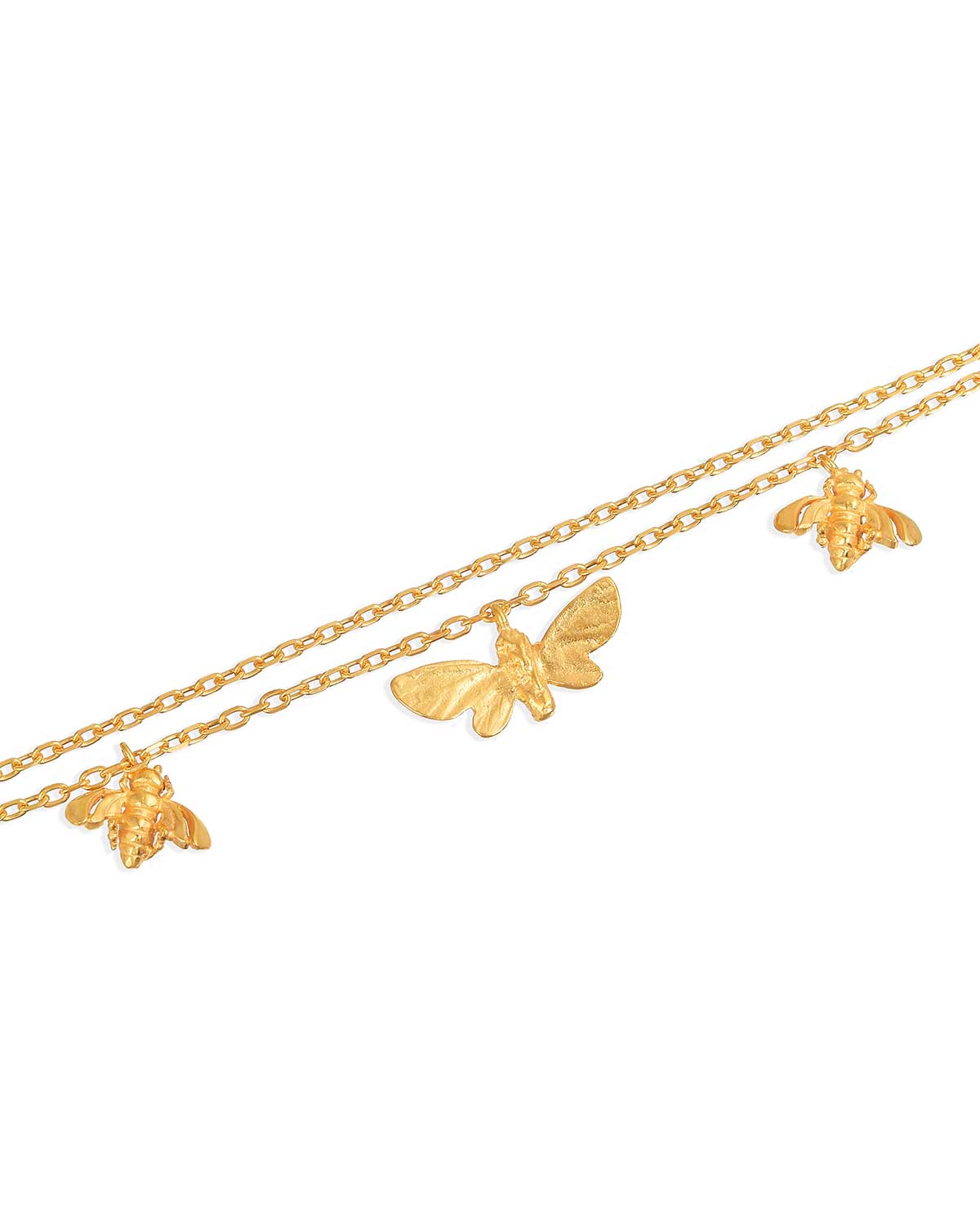 Detailed view of gold bracelet charms, showcasing intricate butterfly and bee designs