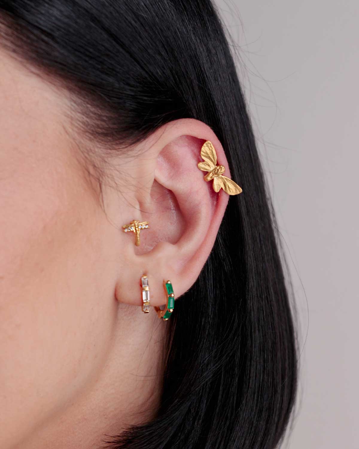 Gold butterfly stud earrings displayed from multiple angles, highlighting craftsmanship