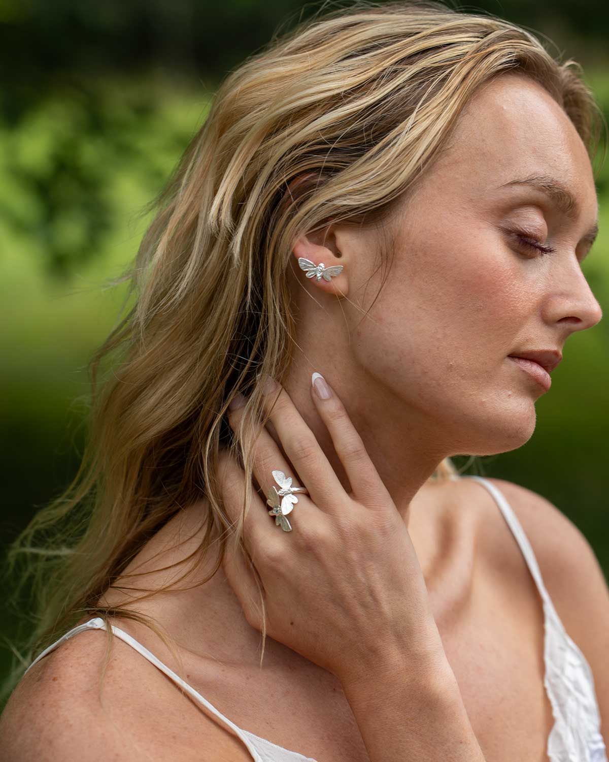 Elegant silver ring with butterfly motifs and Swiss Blue Topaz, representing hope and transformation