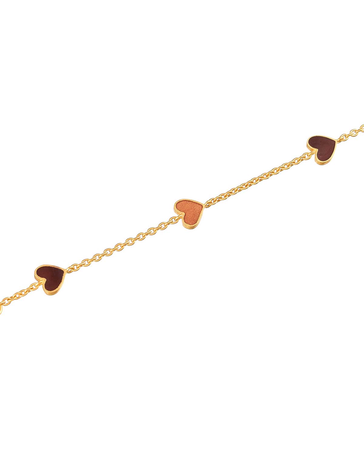 Detailed view of reversible enamel heart charms on a gold bracelet