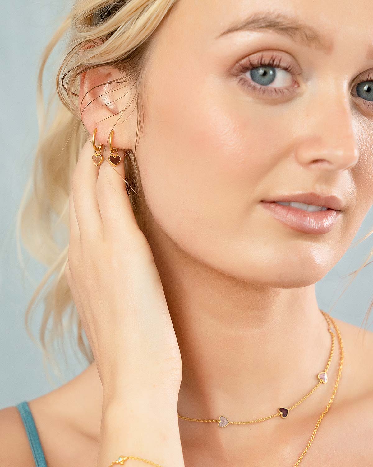Double hoop style gold mini earrings with colourful enamel heart charms