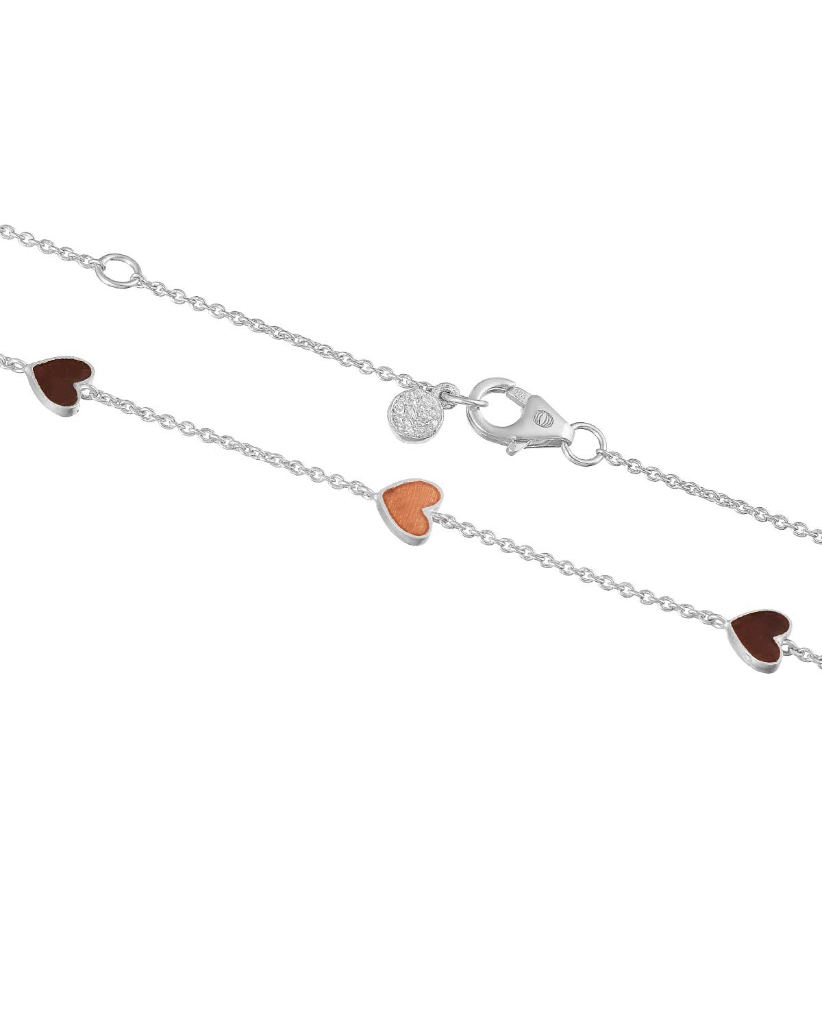 Detailed view of reversible enamel heart pendant on silver necklace