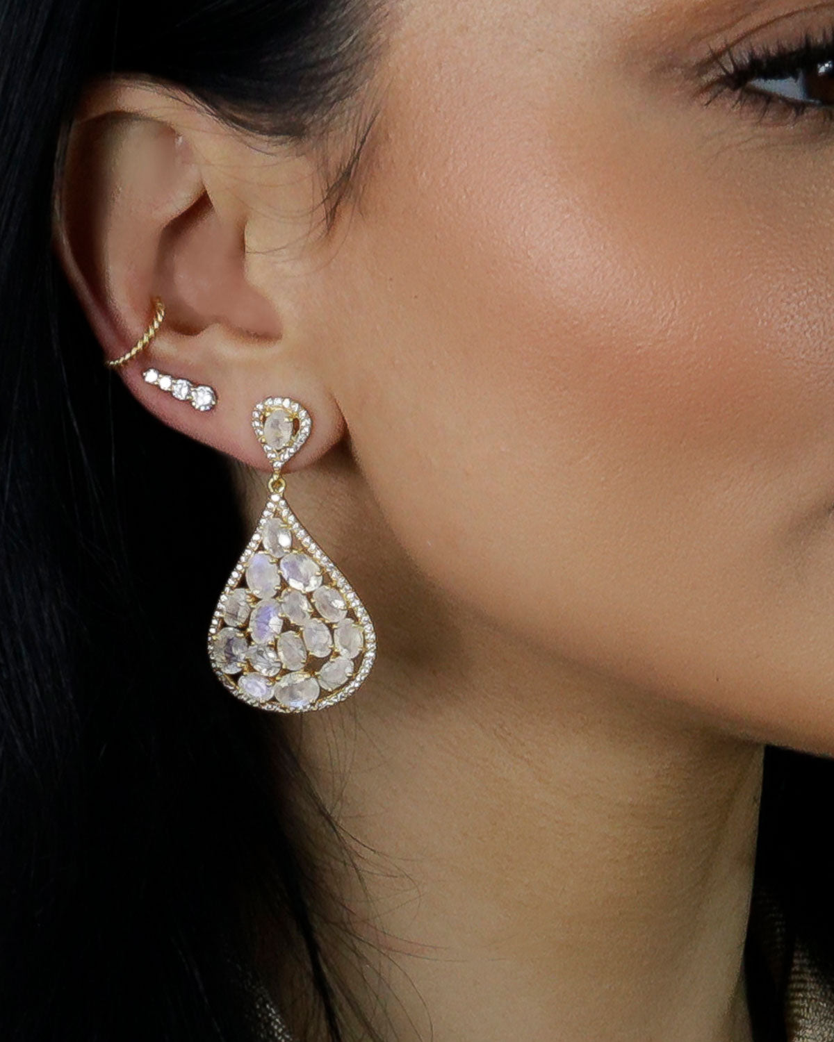 Model wearing gold statement earrings with labradorite gemstones