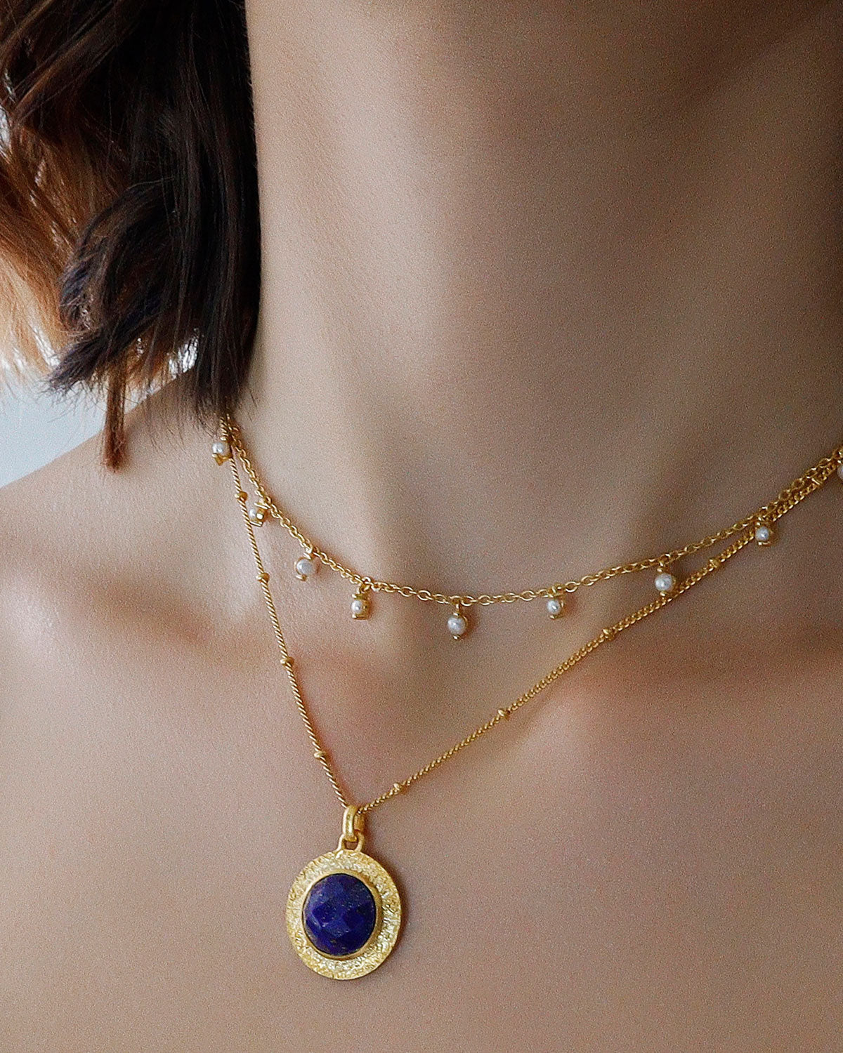 Close-up of circular lapis lazuli pendant with rich blue tones