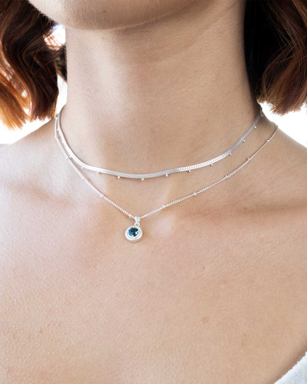 Necklace featuring deep blue London topaz gemstone in silver