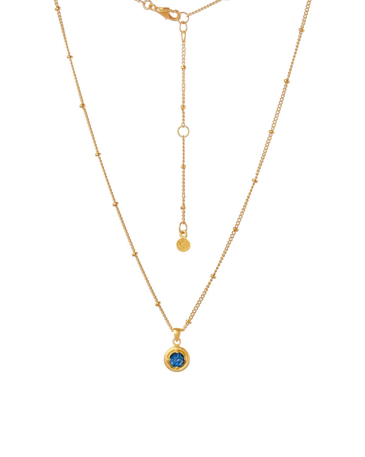 Detailed view of deep blue topaz gemstone in gold vermeil setting