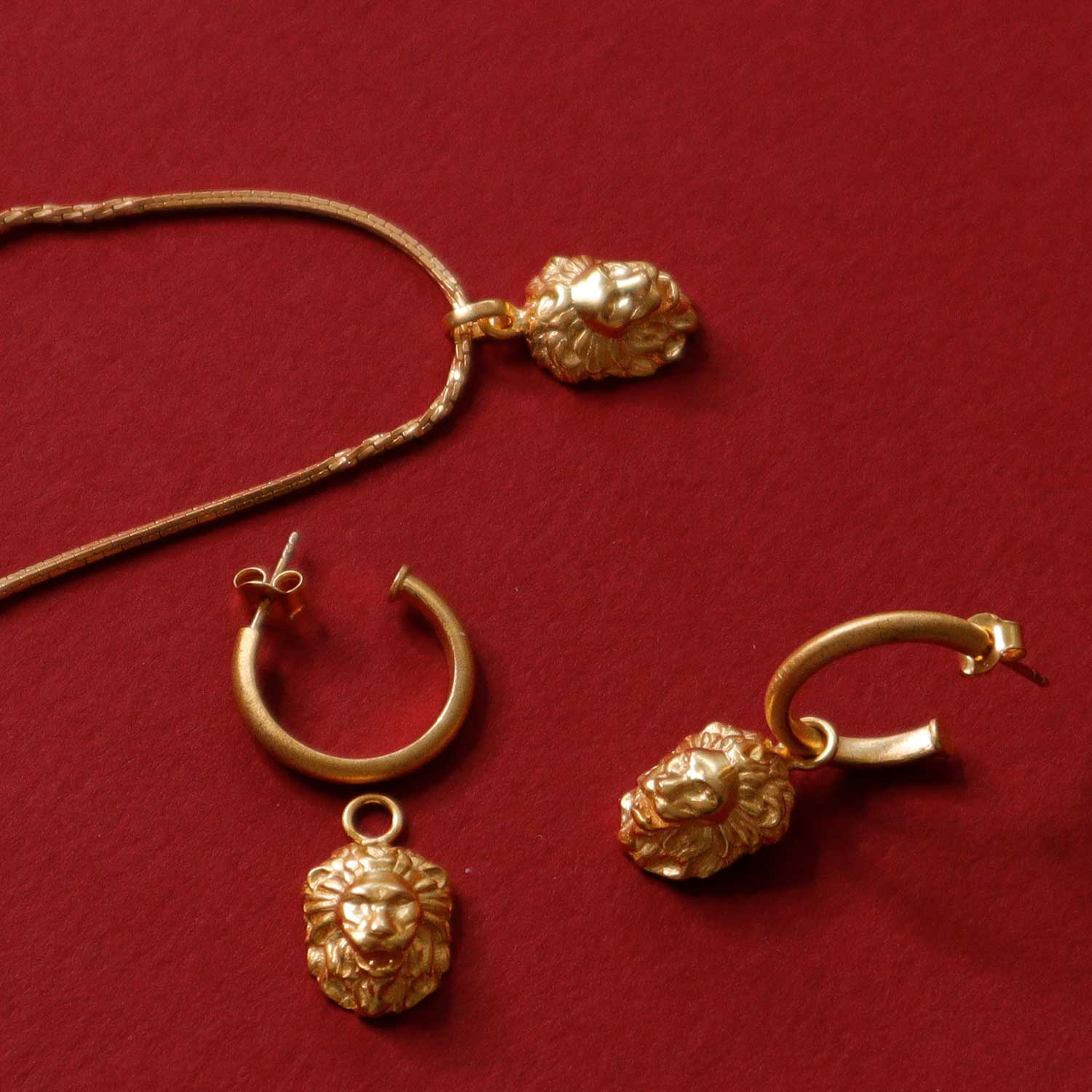 Detailed view of the lion pendant on a gold necklace