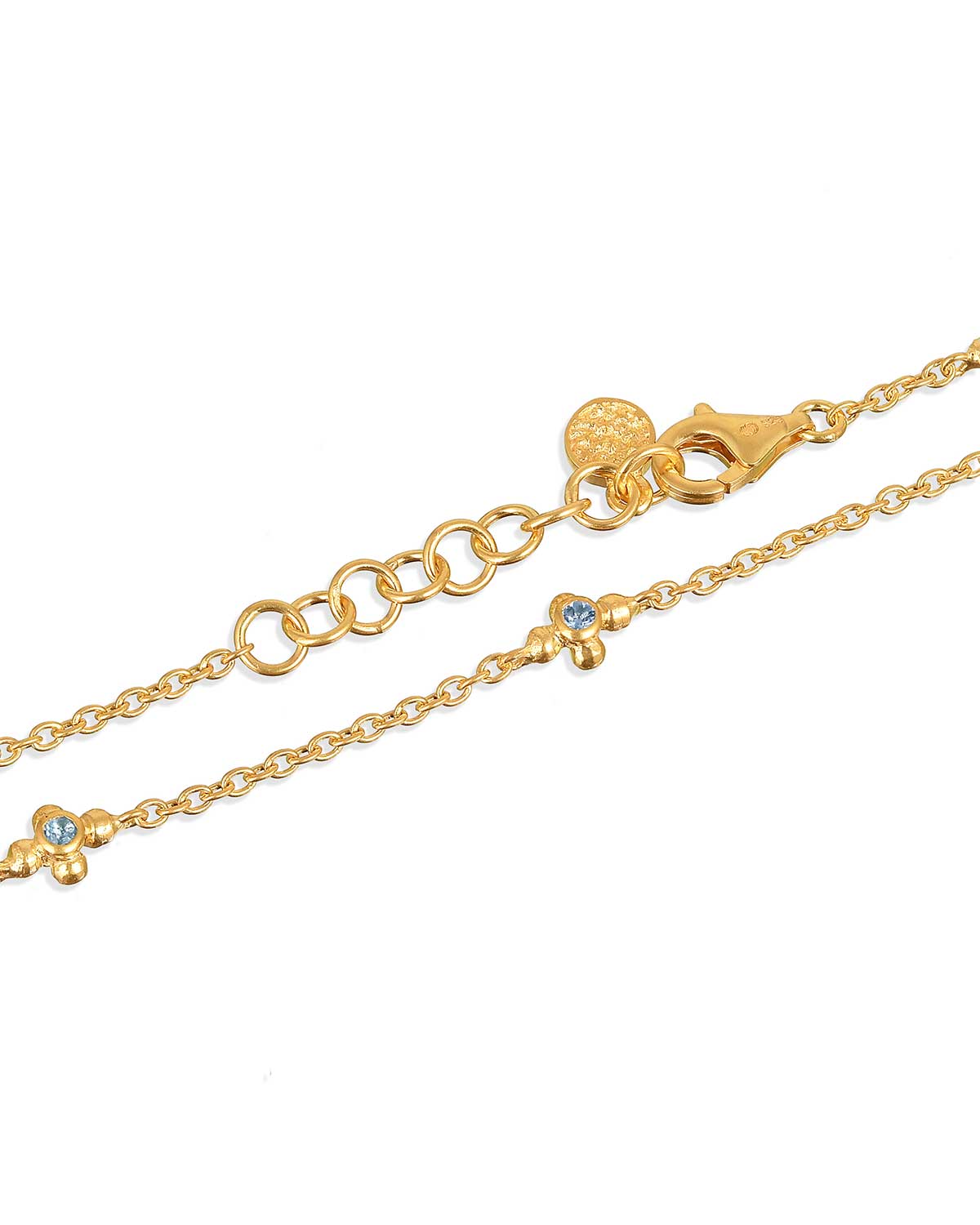 Front view of a gold bracelet featuring blue topaz gemstones and diamonds