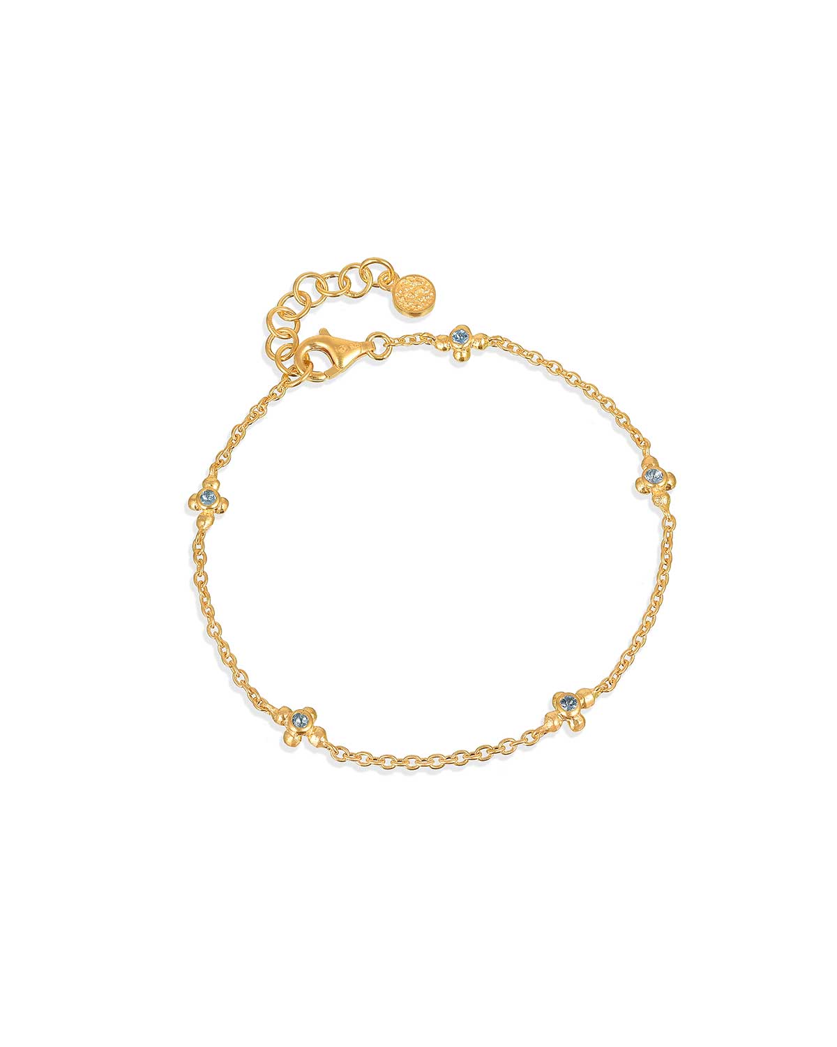Gold bracelet with blue topaz gemstones and diamond details in a delicate design