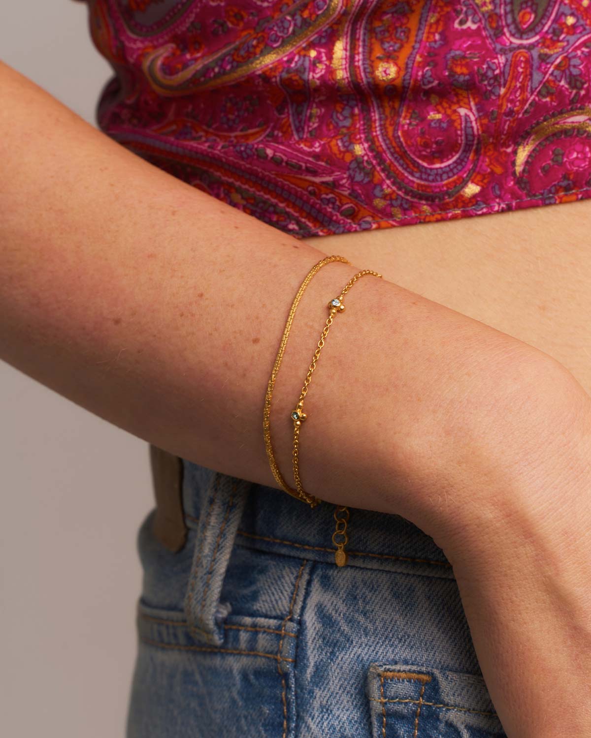 Close-up of silver bracelet featuring blue topaz gemstones and moissanite diamonds