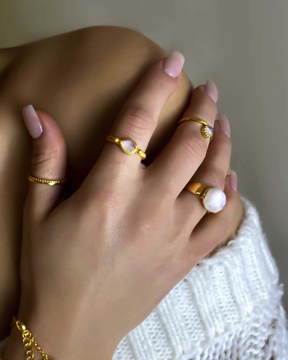 Rainbow moonstone gold ring styled with stacked rings
