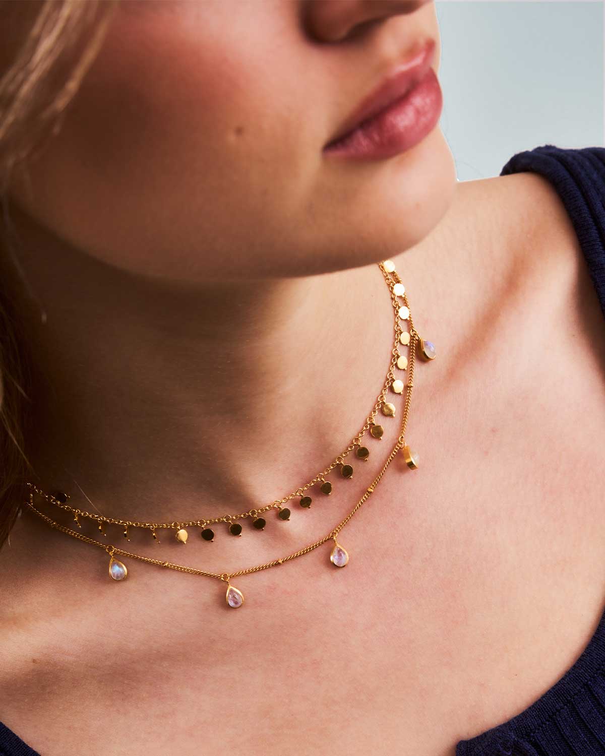 Close-up of gold choker necklace with small handcrafted disk elements