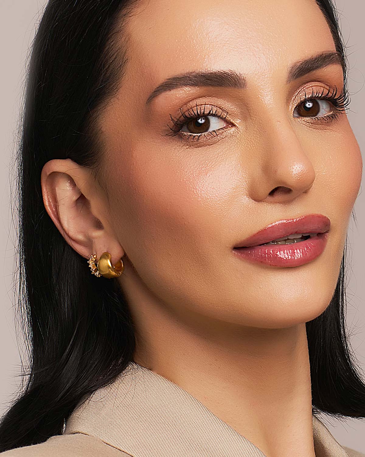 Chunky gold mini hoop earrings stacked with gold studs