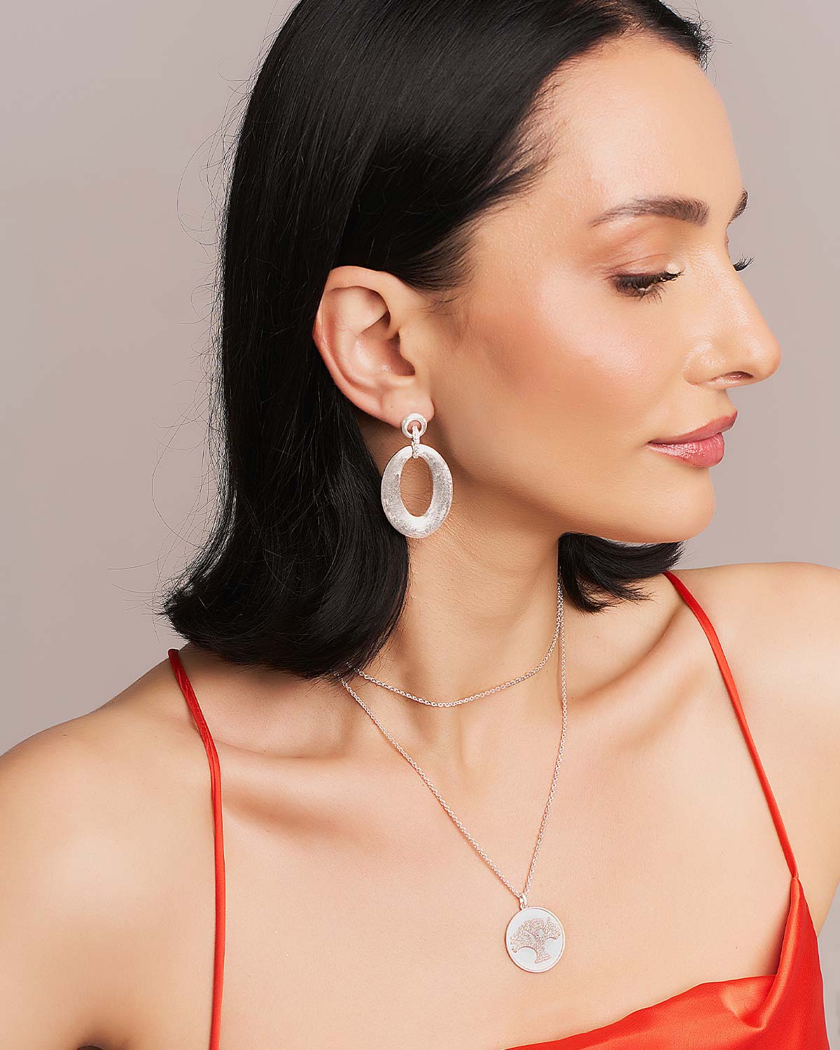 Side view of silver earrings showcasing their light weight and comfortable design