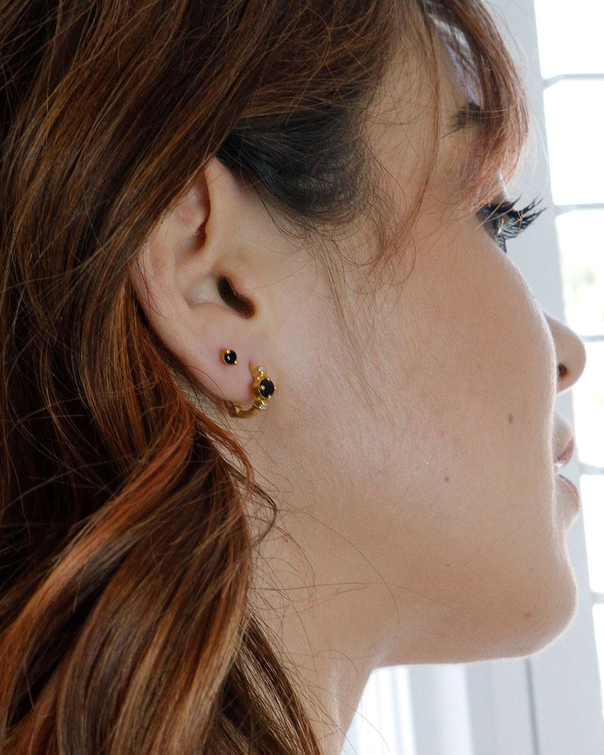 Gold mini hoops with black spinel and pearls in a light matte finish