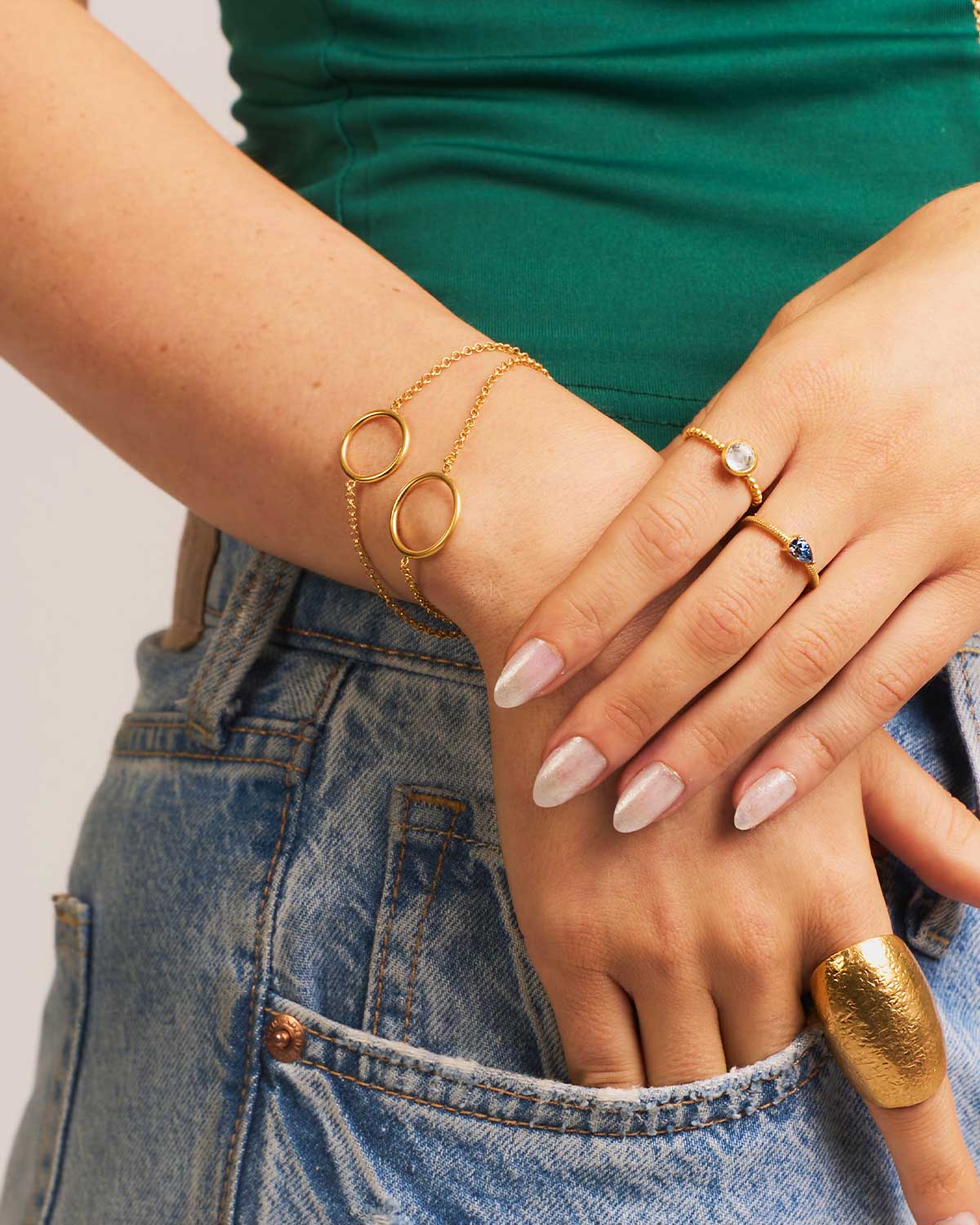 Detailed shot of a gold adjustable bracelet with double circle accents