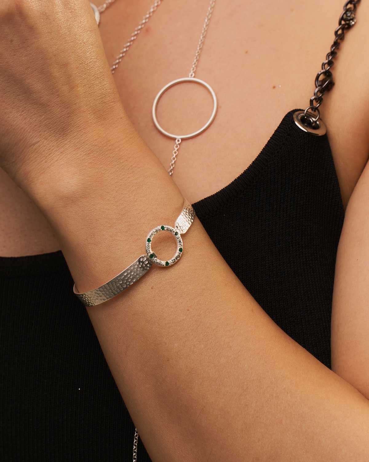 Handmade sterling silver flexible bangle with gemstone detailing and hammered texture