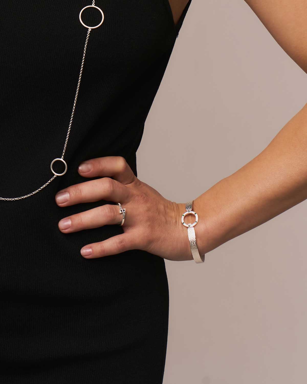 Model wearing sterling silver flexible bangle with a hammered finish