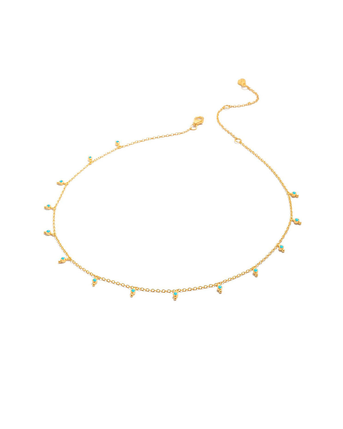 Detail of dainty gold chain with turquoise gemstone accents
