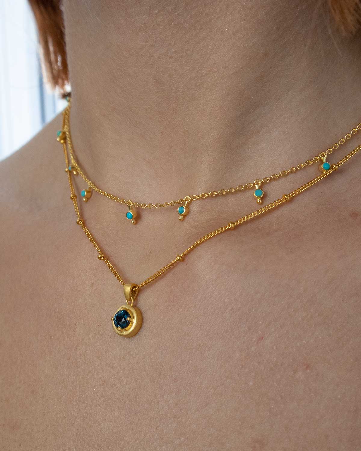 Close-up of turquoise gemstones with handcrafted gold detailing