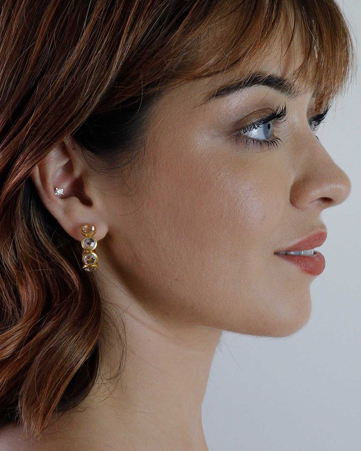 Gold hoop earrings with secure click lock closure and crystal accents