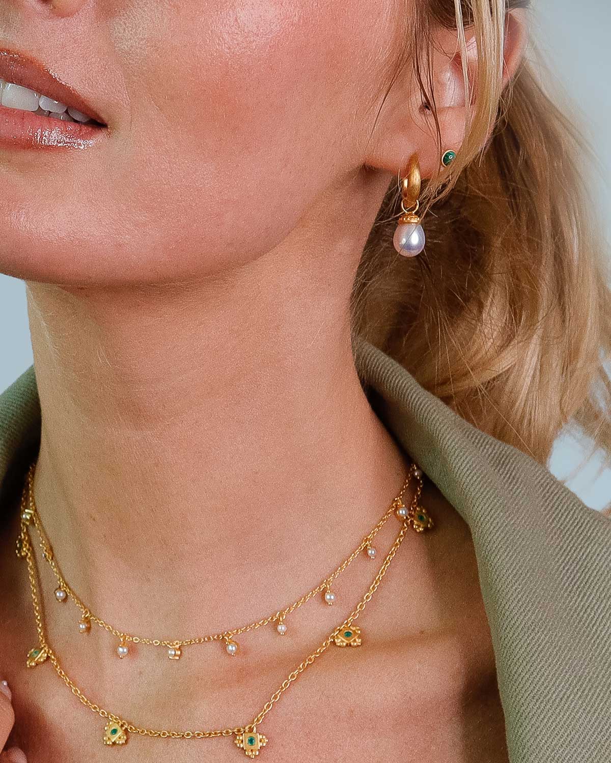 Close-up of gold necklace with genuine graduated pearls