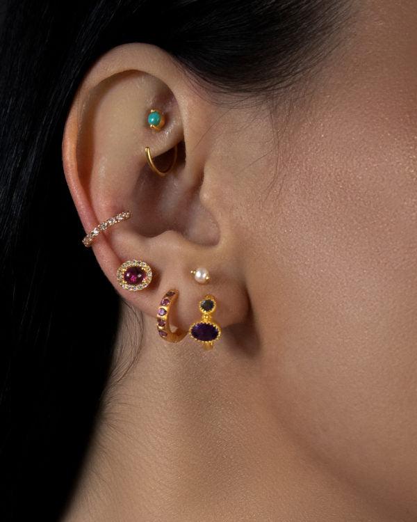 right hand side closeup of model wearing a Pink Tourmaline Gold Studs, and other earrings Moon London women jewellery U.K